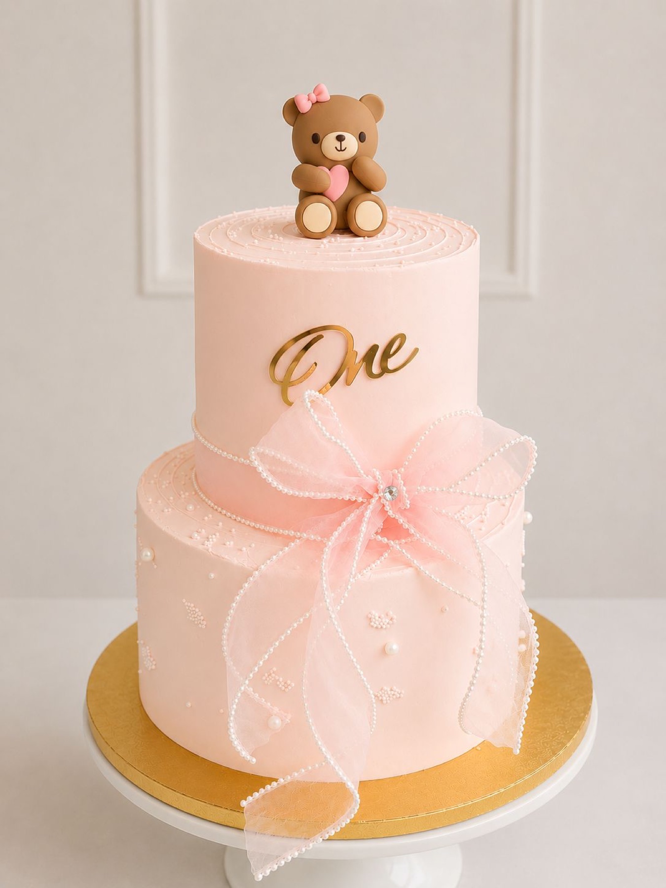 Two tier pink teddy bear first birthday cake
