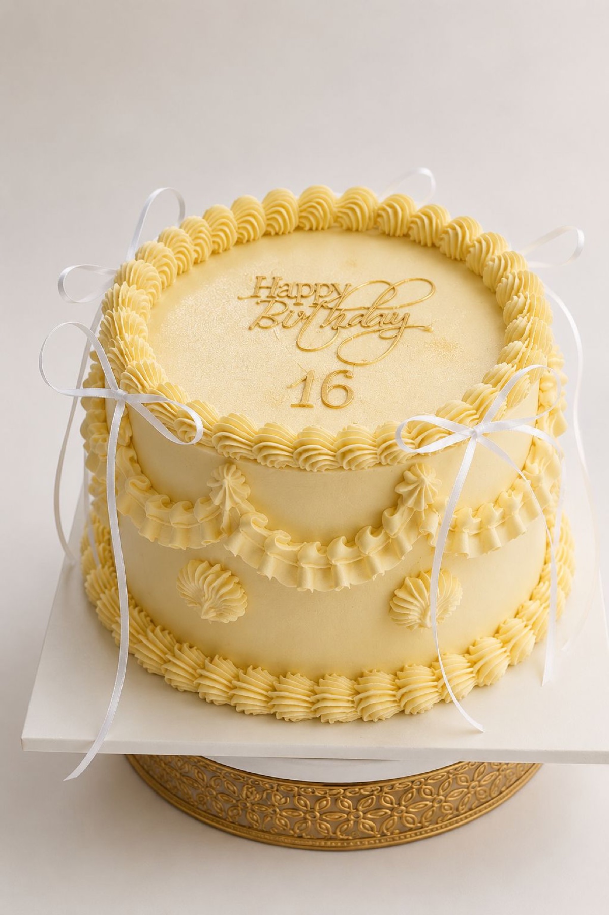 Yellow vintage birthday cake with white bows