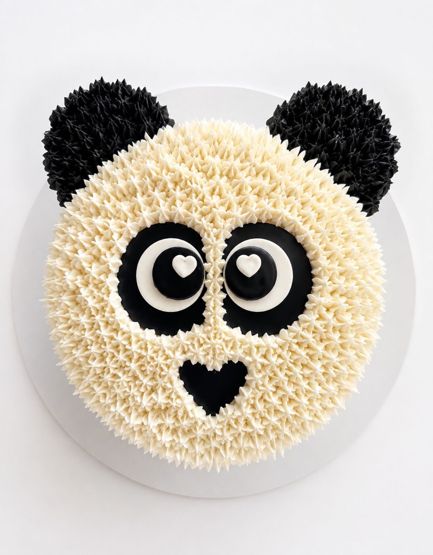 Panda face cake with piped buttercream texture