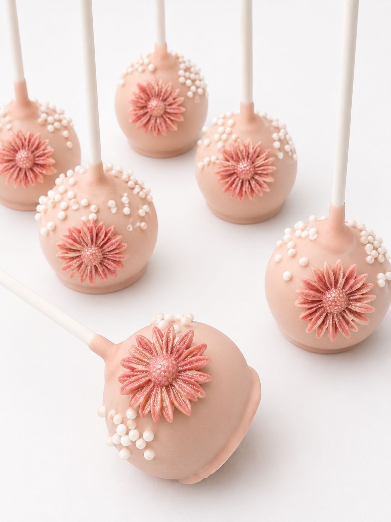 Blush cake pops with floral accents