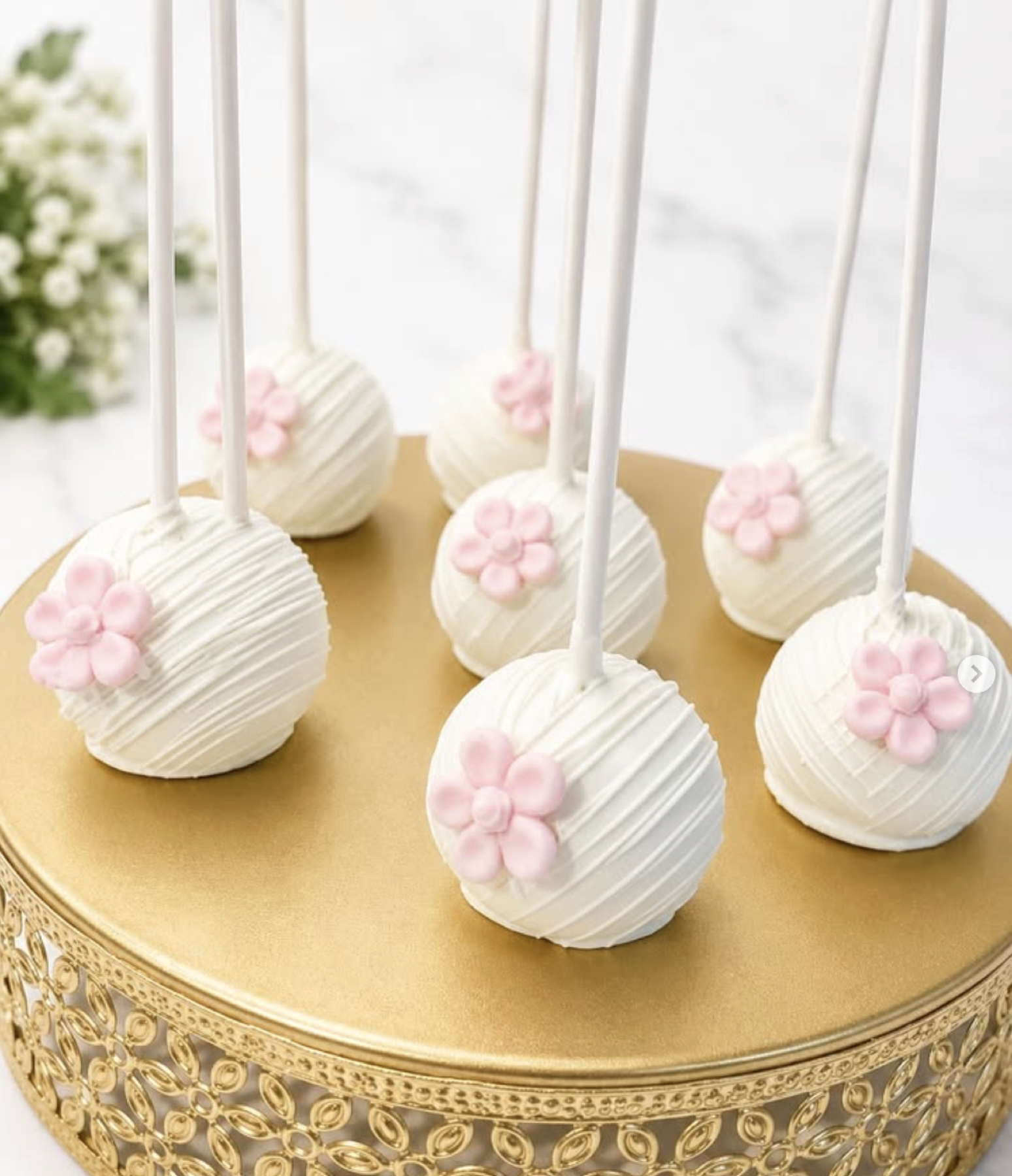 White cake pops with pink flower details